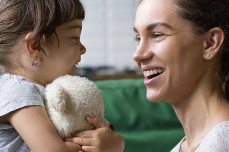 A mom and her daughter laughing